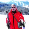 Elderly man out on the ski slopes, using the Inogen G5 Oxygen Concentrator