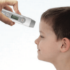 Non Contact Infrared Thermometer in use on a boys forehead